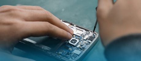Mann repariert Smartphone für einen Business Kunden